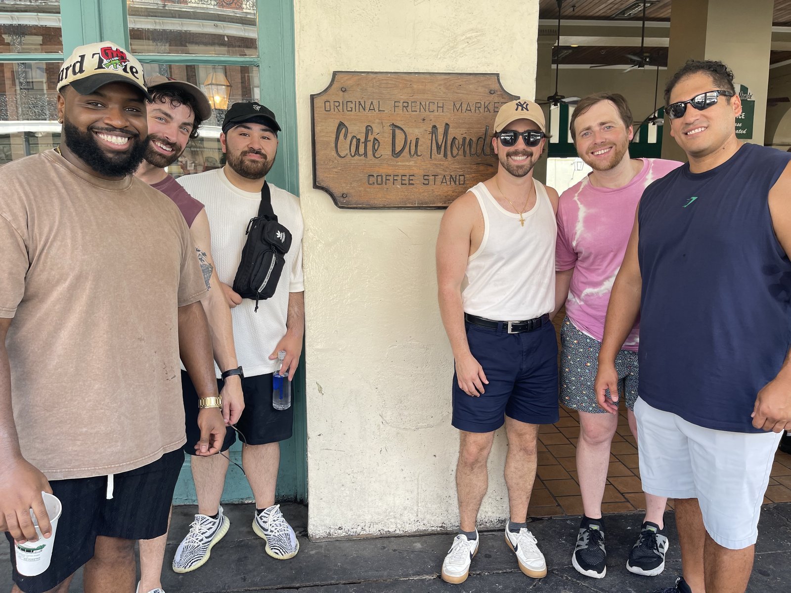 Six friends outside the Cafe du Monde coffee stand in New Orleans