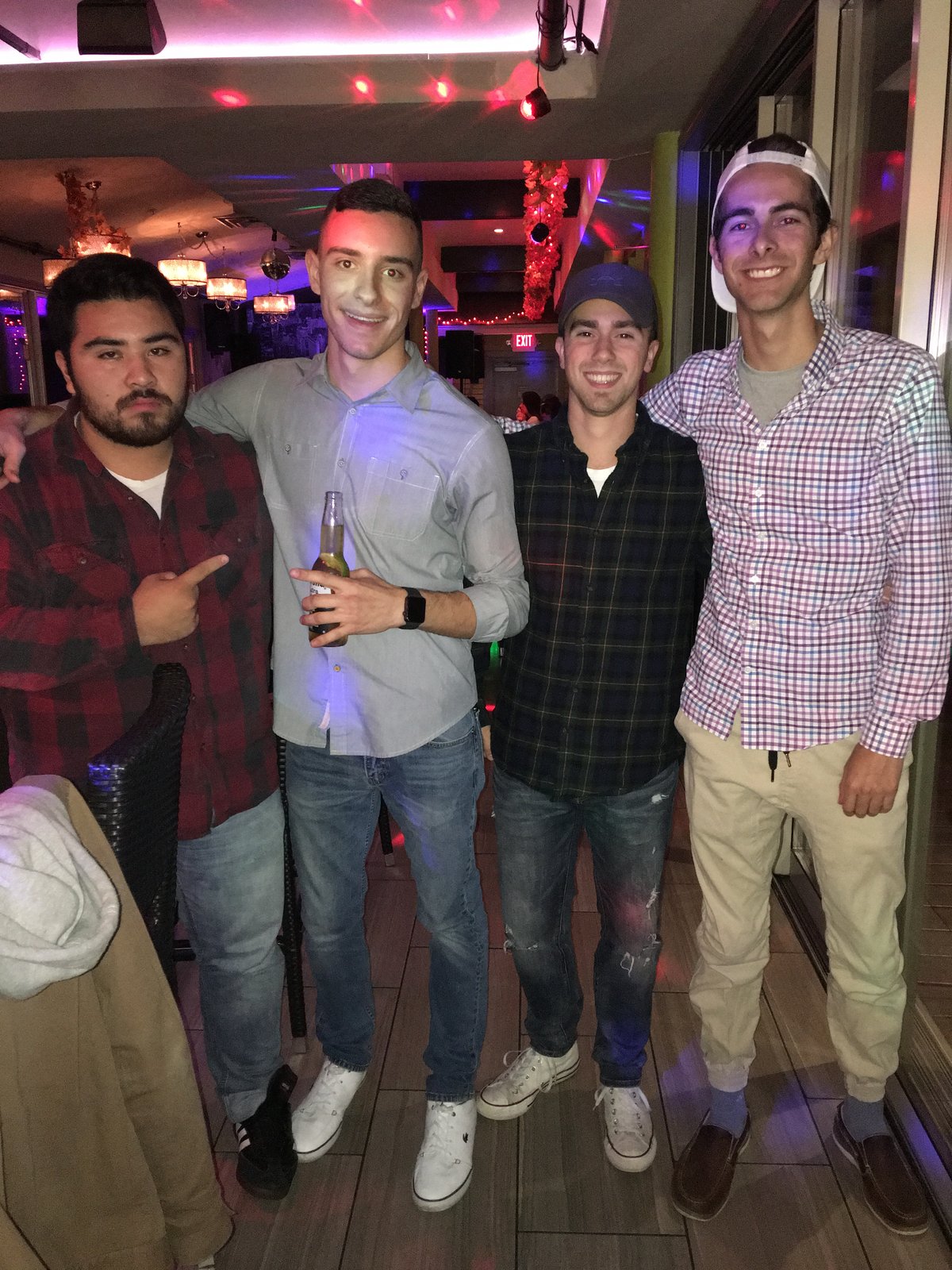 Four friends out together at a bar in the evening