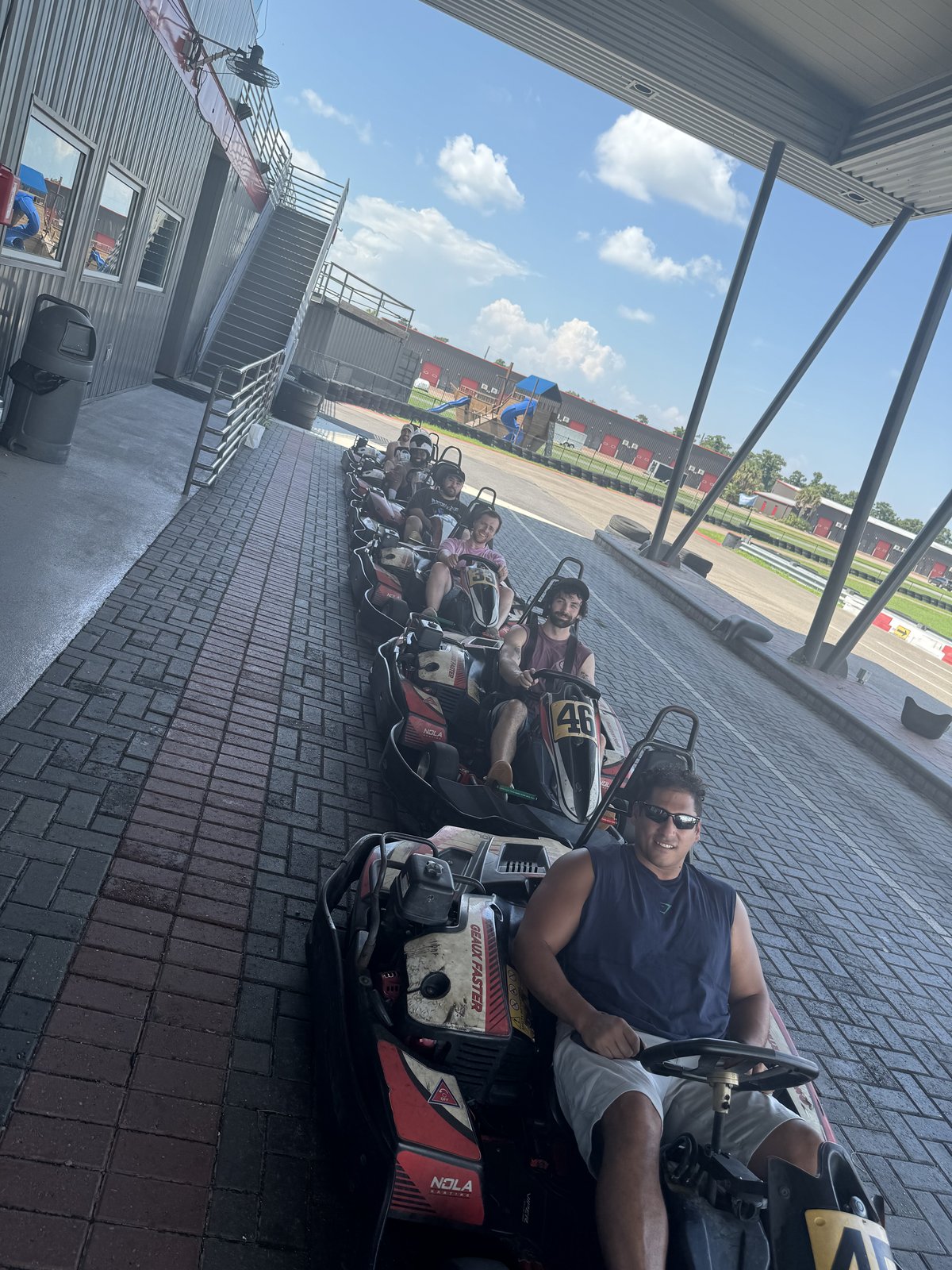A line of go-karts waiting on the track before a race
