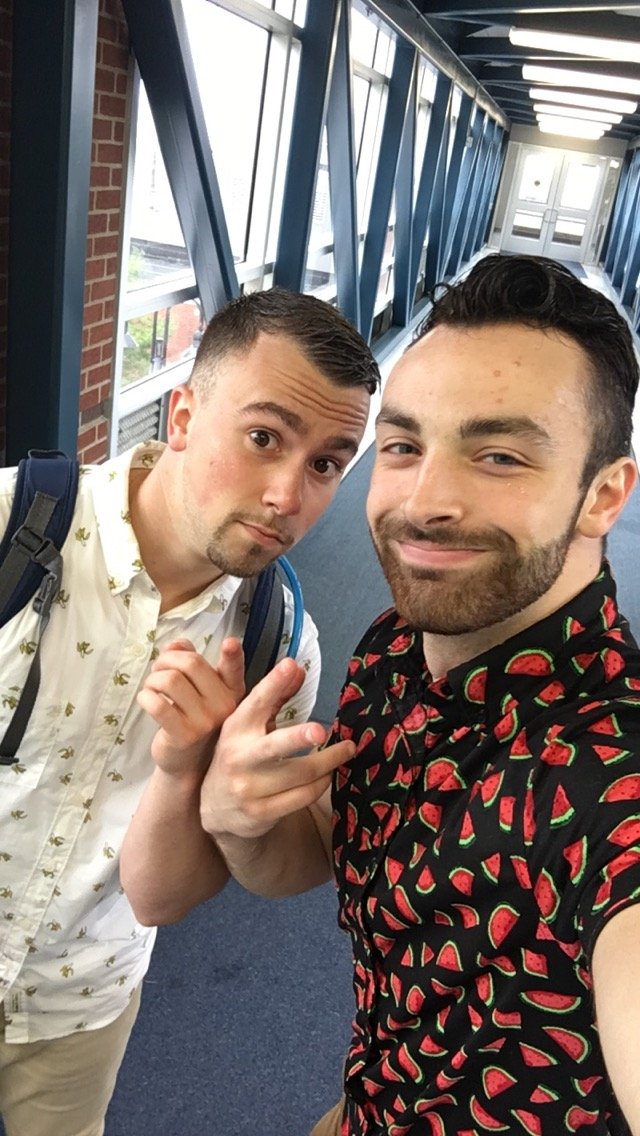Two friends pulling faces for a selfie in a glass walkway