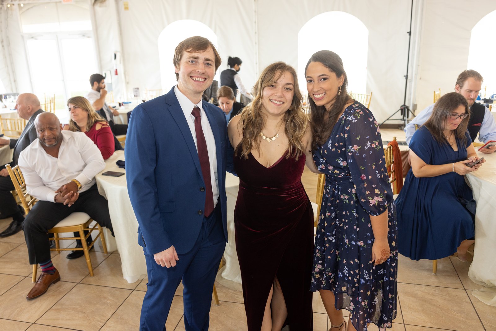 Austin and Bianca with a friend at a marquee reception