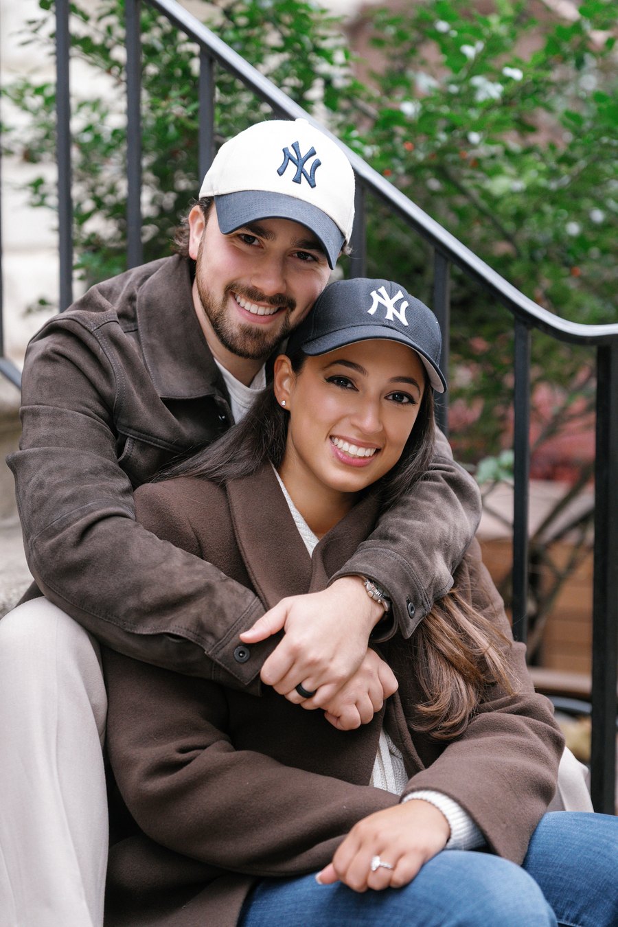 Austin and Bianca sitting together on a brownstone stoop