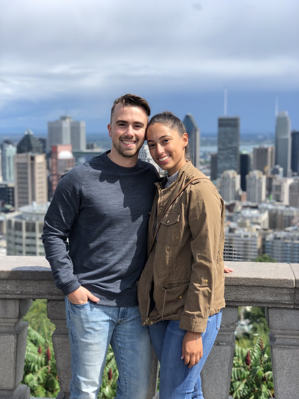 Austin and Bianca at a city overlook with the skyline behind them
